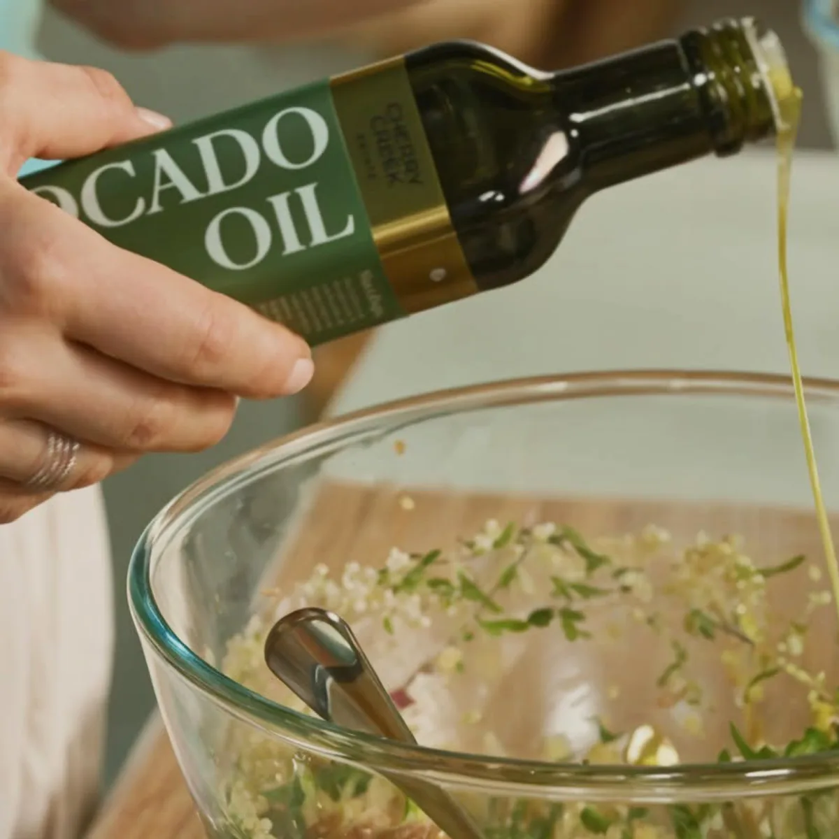 Cherry Creek Estate avocado oil poured over a fresh dish